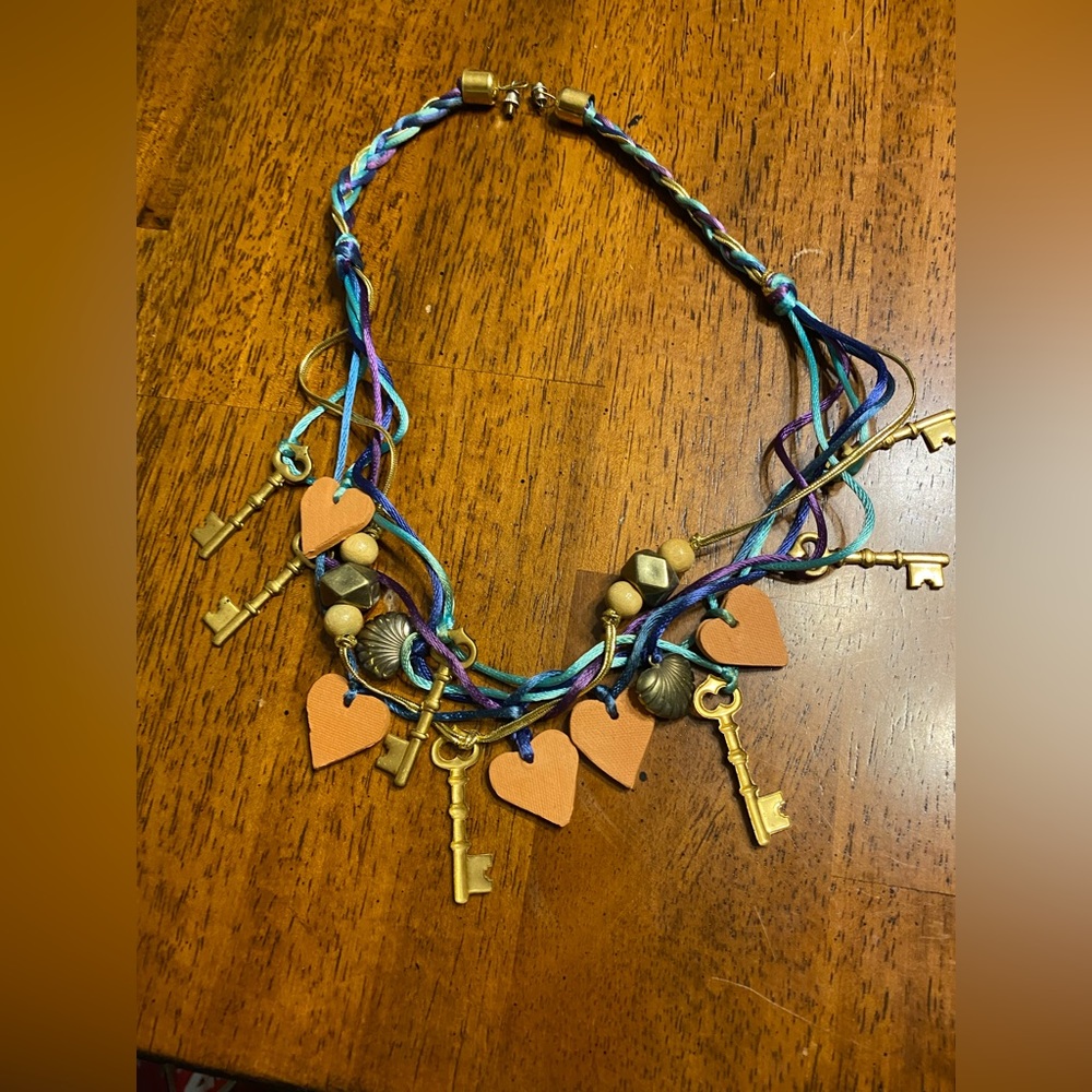 Key and bead braided cord necklace. Approximately 22 inches long.